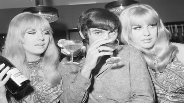 Manchester United footballer George Best celebrates the opening of his fashion boutique with a few glasses of champagne.14th September 1967. 