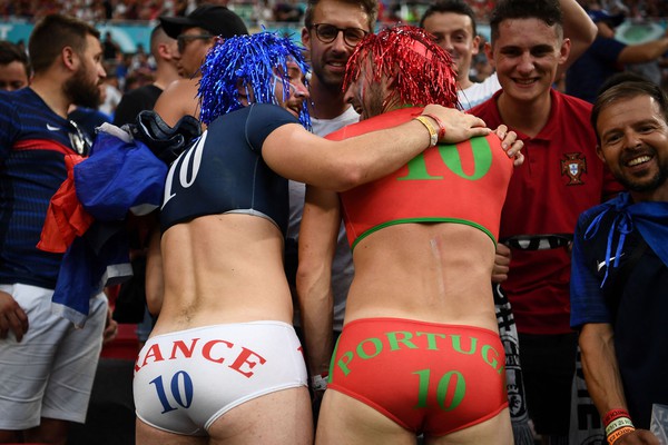 TOPSHOT - A France (L) and Portugal (R) supporter pose before the UEFA EURO 2020 Group F football match between Portugal and France at Puskas Arena in Budapest on June 23, 2021. (Photo by FRANCK FIFE / POOL / AFP) (Photo by FRANCK FIFE/POOL/AFP via Getty Images)