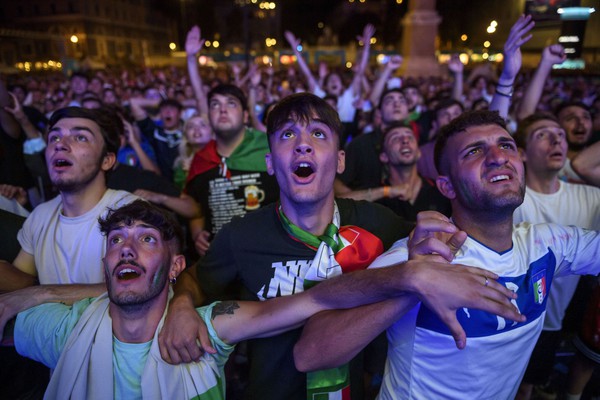 ROME, ITALY - JULY 06: Italian fans react as they watch on giant screens at Piazza del Popolo fan zone the Euro 2020 Semi-Final match between Italy and Spain, played at Wembley stadium, on July 6, 2021 in Rome, Italy. The tournament was postponed from last year due to the Covid-19 pandemic. (Photo by Antonio Masiello/Getty Images)
